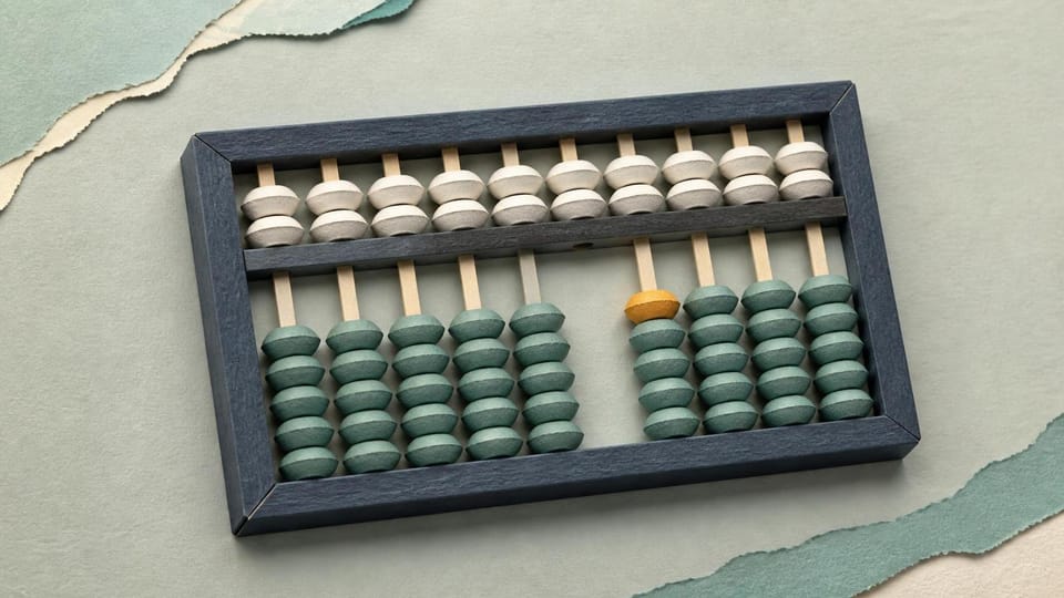 Precisely aligned paper abacus representing a reconciled ledger.